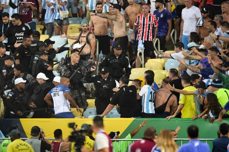 Fifa investigating crowd disruption in Brazil-Argentina clash email whatsapp twitter facebook Fifa investigating crowd disruption in Brazil-Argentina clash Fans of Argentina clash with Brazilian police before the start of the 2026 Fifa World Cup qualification match between Brazil and Argentina at Maracana Stadium in Rio de Janeiro, Brazil November 21, 2023. ― AFP pic Join us on our WhatsApp Channel, follow us on Instagram, and receive browser alerts for the latest news you need to know. Saturday, 25 Nov 2023 8:33 AM MYT ZURICH, Nov 25 ― Fifa has started disciplinary proceedings over the crowd disturbances that caused a delay in the World Cup qualifier between Brazil and Argentina at the Maracana Stadium, football's world governing body said yesterday. Advertisement Brazil and Argentina fans started fighting behind one of the goals during the national anthems at Thursday's game, prompting police to charge at the travelling contingent with batons drawn. The visiting world champions, led by captain Lionel Messi, went over to the terraces to try and calm the situation before leaving the pitch for more than 10 minutes. ADVERTISEMENT “Fifa can confirm that its Disciplinary Committee has opened proceedings against the Brazilian Football Association (CBF) and the Argentinian Football Association (AFA),” Fifa said in a statement yesterday. Argentina face disciplinary action for potential breaches of 'Articles 17.2 and 14.5' of the Fifa disciplinary code related to crowd disturbance and delayed kick-off respectively. Fifa added that Brazil are under investigation for potential violations of 'Article 17', which relates to maintaining order and security during matches. ADVERTISEMENT The game started after the long delay and Argentina won 1-0 with a 63rd-minute header from defender Nicolas Otamendi. ― Reuters